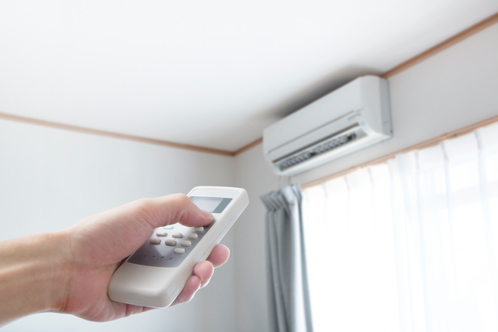 man holding air conditioner remote control