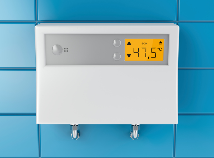 Automatic water heater attached on blue tiled wall