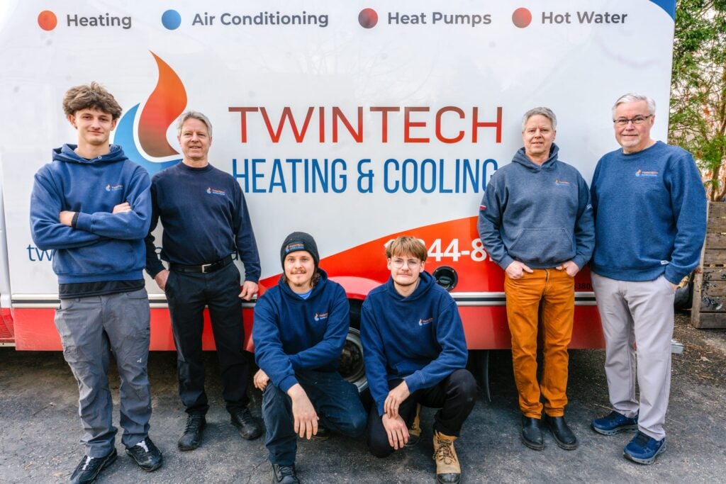 Twintech Heating and Cooling technician team standing in front of a company van in Durham Region, Ontario.